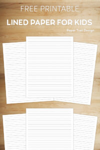 Kids lined handwriting paper on a wooden background with text overlay free printable lined paper for kids